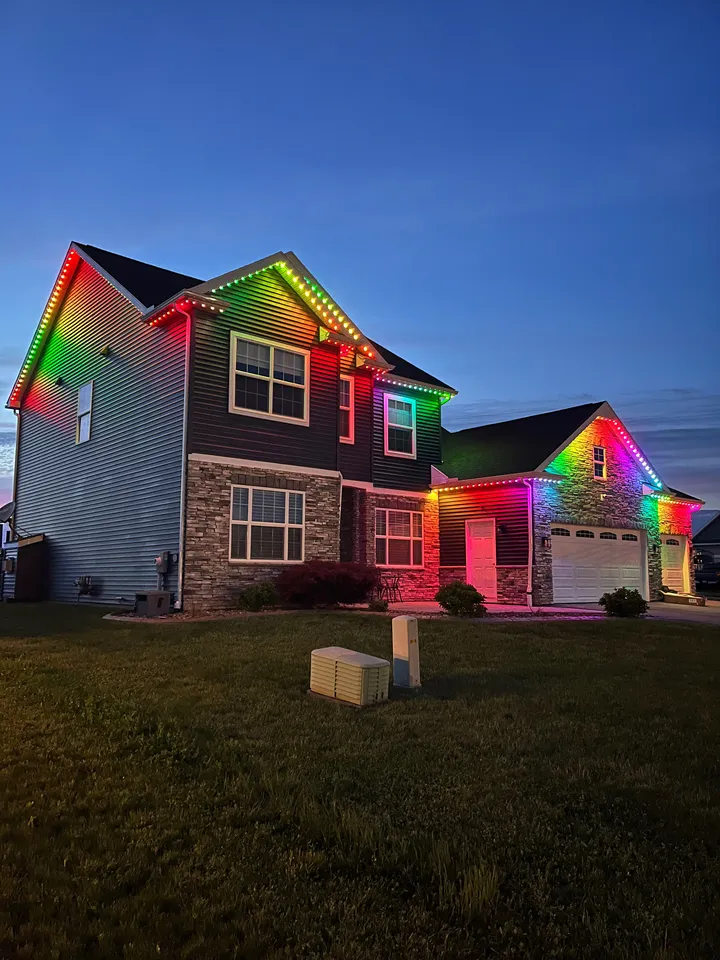 Churchville home lit in rainbow colors at dusk