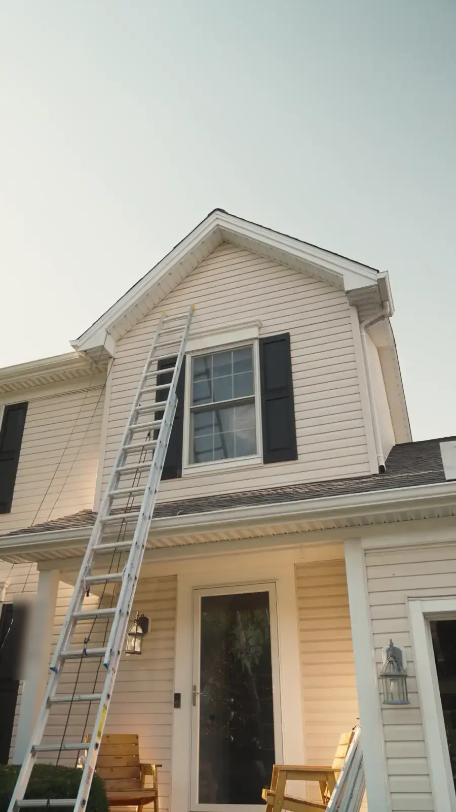 The house in afternoon light with a ladder still against it during install