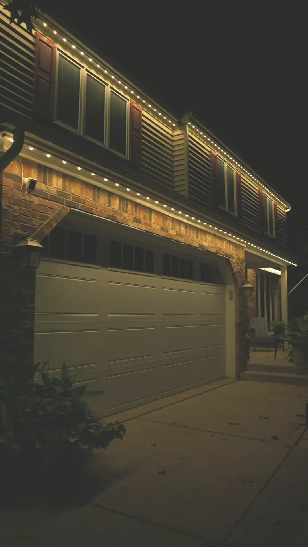 Lancaster home with warm white permanent lights over the garage
