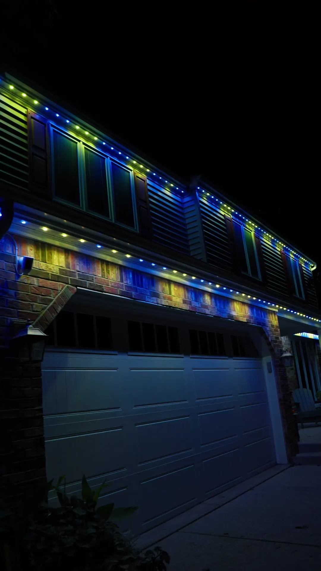 The same Lancaster home lit blue and gold