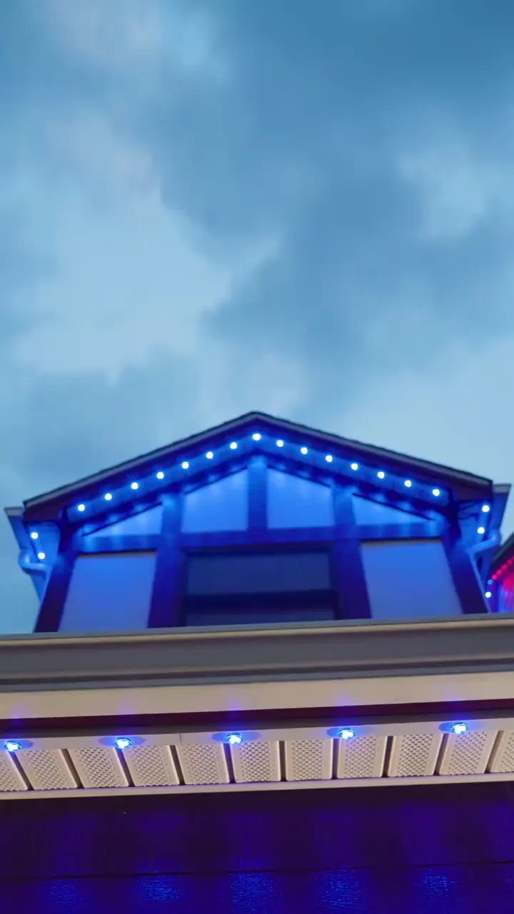 The same dormer lit blue after sunset