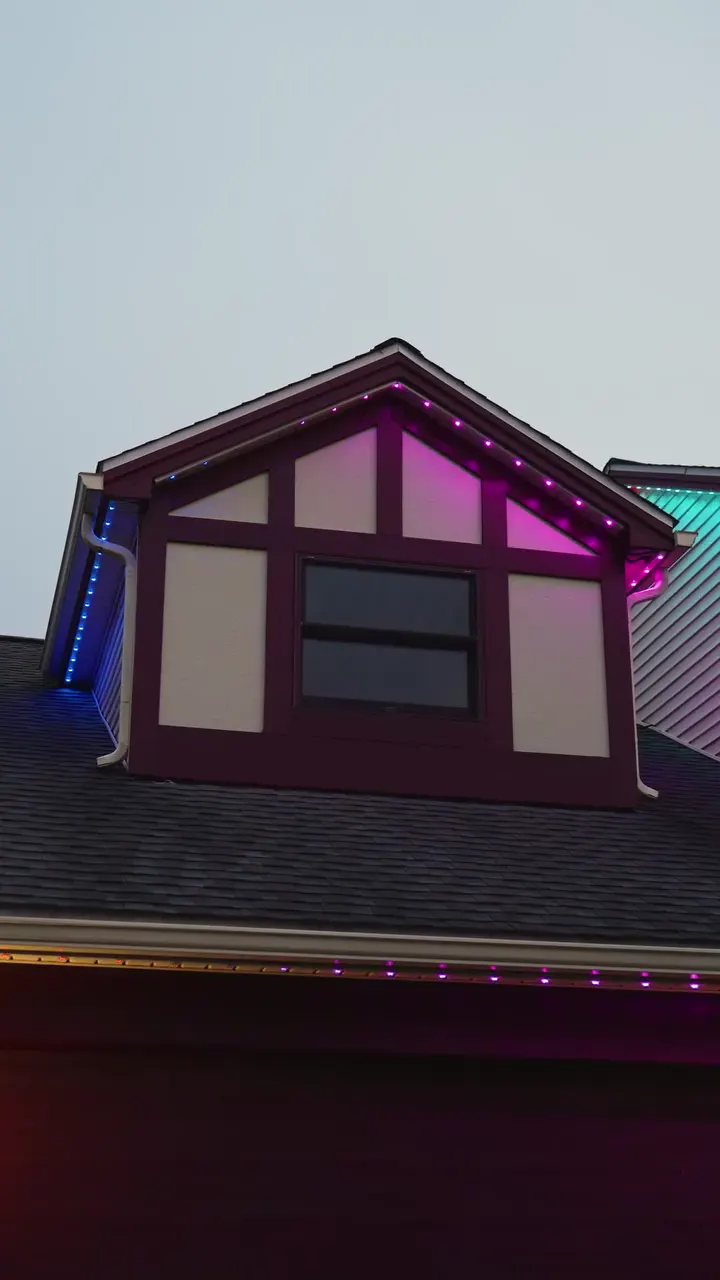 The dormer lit pink and red