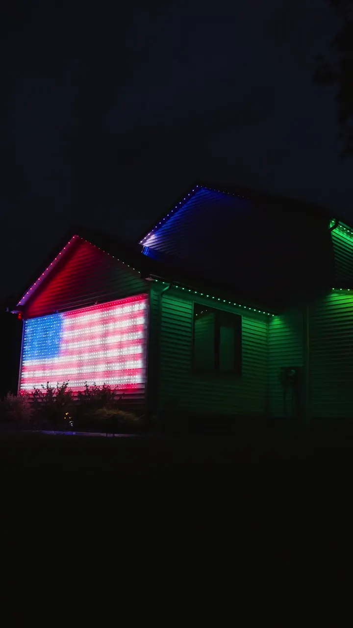 Lancaster Tudor home with an American flag pattern lit across the garage roofline